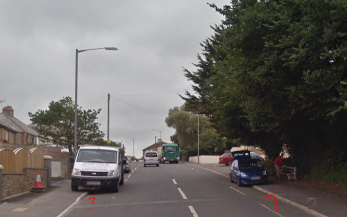 The cycle gutter on Kings Hill with parked cars on it.